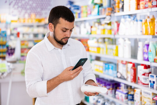 Male customer scans barcode on a medicine box using her phone