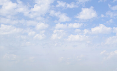 Altocumulus clouds against a light blue sky. Idyllic clouds. The concept of lightness