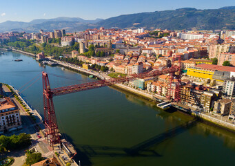 Fototapeta na wymiar Aerial view of Vizcaya bridge over the river and cityscape at Portugalete, Spain