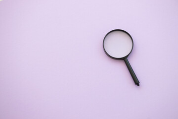 magnifying glass on violet background. Search concept