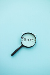 magnifying glass on blue background. Search concept