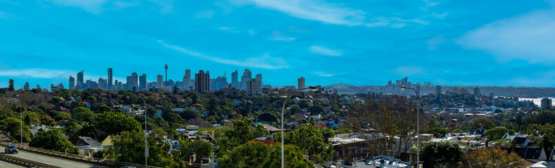 Obraz premium Panorama view of Sydney CBD and Sydney Harbour. Distant view of High-rise office towers and high-rise apartment buildings. Suburban Sydney Suburbs in the foreground NSW Australia 