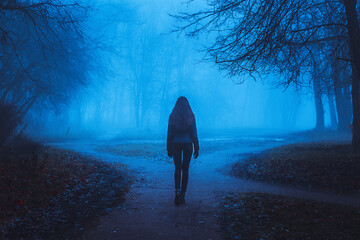 Girl on the road in a mysterious forest. Background wallpaper. Strange forest. Mystic atmosphere....