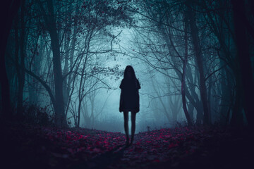 Girl on the road in a mysterious forest. Background wallpaper. Strange forest. Mystic atmosphere....