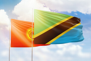 Sunny blue sky and flags of tanzania and kyrgyzstan