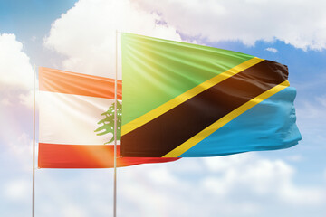 Sunny blue sky and flags of tanzania and lebanon