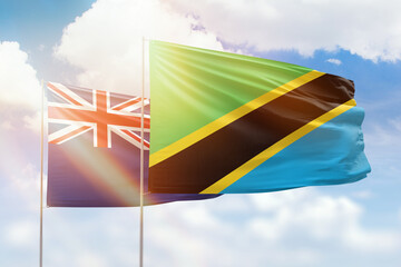 Sunny blue sky and flags of tanzania and new zealand