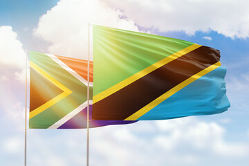 Sunny blue sky and flags of tanzania and south africa
