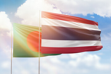 Sunny blue sky and flags of thailand and bangladesh