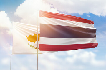 Sunny blue sky and flags of thailand and cyprus