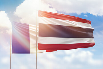 Sunny blue sky and flags of thailand and france