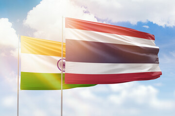 Sunny blue sky and flags of thailand and india