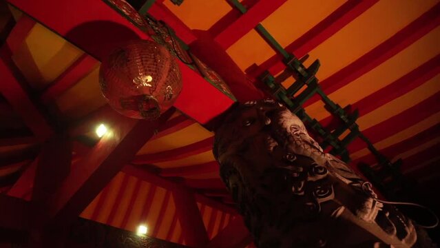 Historic pagoda building interior. Dragon ornament with beautiful shape on pillar with dim lights at Sam Poo Kong temple, Semarang