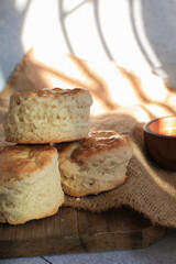 Scones serve with homemade currant jam under sunlight. Fresh yummy tasty delicious English pastry for afternoon