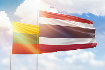Sunny blue sky and flags of thailand and lithuania