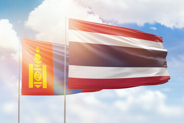 Sunny blue sky and flags of thailand and mongolia