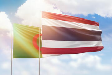 Sunny blue sky and flags of thailand and algeria
