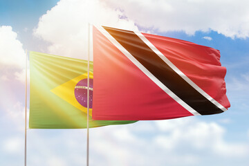 Sunny blue sky and flags of trinidad and tobago and brazil