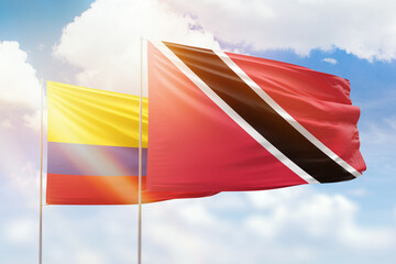 Sunny blue sky and flags of trinidad and tobago and colombia