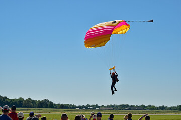 A parachutist comes in for a landing at the opening of an airshow.
