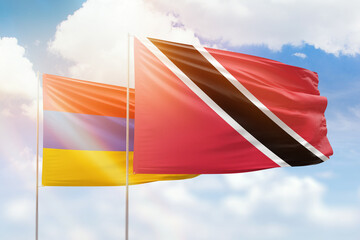 Sunny blue sky and flags of trinidad and tobago and armenia