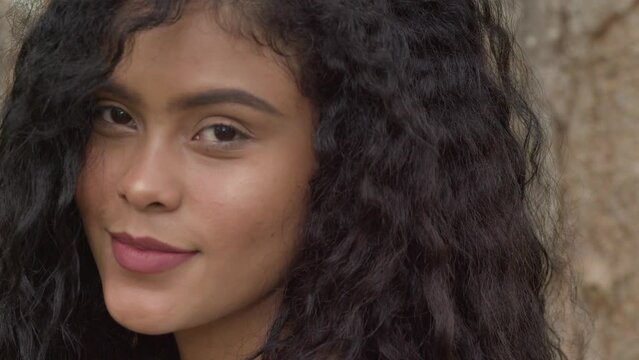 Facial close up of a pretty curly hair latina girl