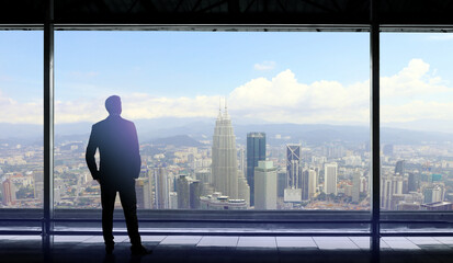 Fototapeta na wymiar Businessman looking at wide open view window