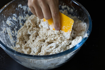 全粒粉と小麦粉をこねる手　A hand kneading dough flour & wholewheat 2022.05.17