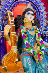 Idol of Goddess Saraswati with veena, a musical instrument, at Kolkata, West Bengal, India. Saraswati is Hindu goddess of knowledge, music, art, wisdom, and learning.