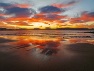 Winter sunrise at the seaside with high cloud and reflections