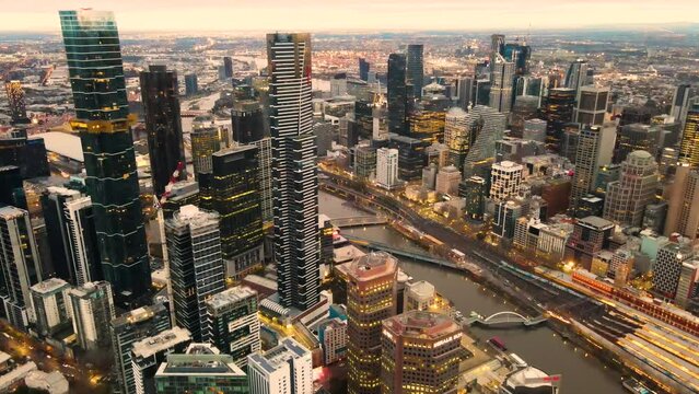 
Aerial drone pullback view of Melbourne City, Victoria, Australia above Yarra River in the early morning 
