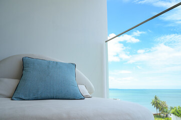 blue pillow on balcony with sky and sea