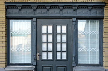 Wood door and windows on peach colored wall in Kyiv Ukraine