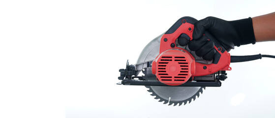 one hand wearing black gloves holding circular saw isolated white background