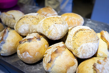 A finished batch of artisan wheat bread, just out of the oven. Front view.