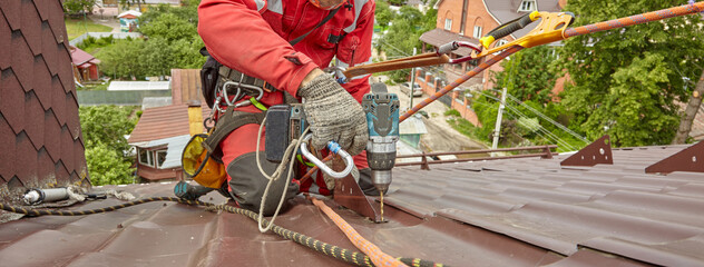 A specialist is repairing the roof. Rope access	