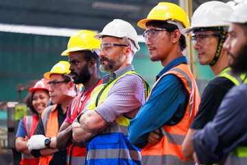 Arms crossed. Professional team working at workplace. Unity and teamwork concept. Portrait engineer factory manager worker and mechanic team together in factory workplace