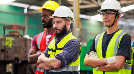 Arms crossed. Professional team working at workplace. Unity and teamwork concept. Portrait engineer factory manager worker and mechanic team together in factory workplace