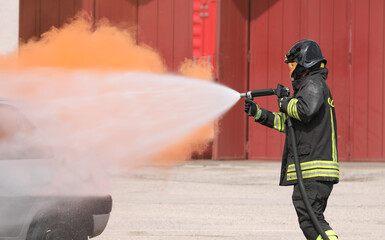 Fire Brigade extinguishes the fire with the hose by spraying water at very high pressure towards...