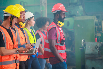 Unity and teamwork concept. african american male engineer factory manager worker and mechanic team walking together in factory workshop