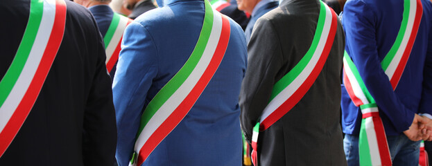 elegant Italian mayors with elegant dress during the official ceremony with the tricolor green...