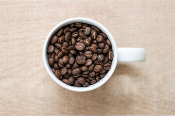 Fototapeta premium Coffee cup and coffee beans on wooden background.