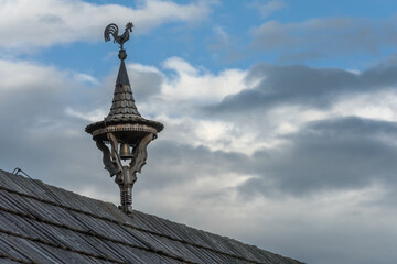 weathercock with a bell on a small wooden tower