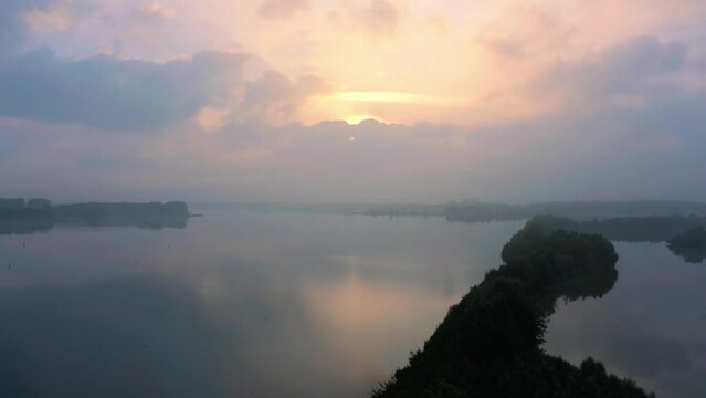 Aerial Arkemheen polder dikes landscape, early morning mist, backwards