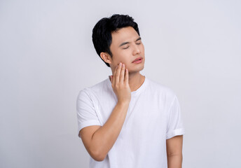 Handsome Asian man suffering from health problems and toothache on white. He touched his face with his hand.
