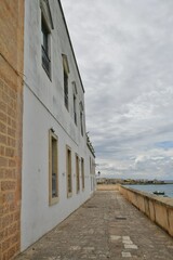 A narrow street among the old houses in the historic center of Otranto, a town in Puglia in Italy.