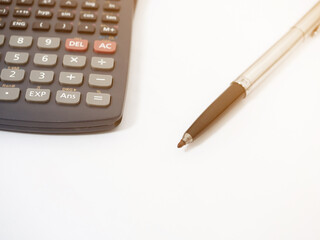 Close up pen with calculator isolated white