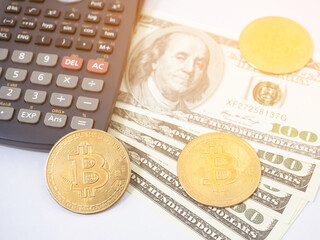 Closeup bitcoin with money the digital money concept light flare,Bitcoin money with calculator