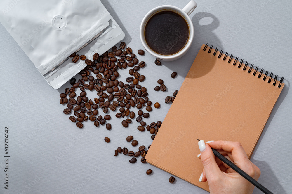 Sticker Cup of coffee with notebook on gray background top view