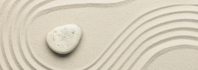 Fototapeta na wymiar Stone on sand with lines, top view. Zen concept